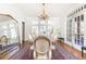 Formal dining room with ample seating, large mirror, and chandelier at 57 Rumson Ne Way, Atlanta, GA 30305