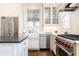 Contemporary kitchen featuring white cabinets, stone countertops, stainless appliances, and a large farmhouse sink at 57 Rumson Ne Way, Atlanta, GA 30305