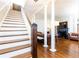 Bright living room featuring a staircase, hardwood floors, decorative columns and a beautiful fireplace at 57 Rumson Ne Way, Atlanta, GA 30305