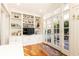 Cozy living room featuring built-in shelving, a television, and glass doors opening to an outdoor space at 57 Rumson Ne Way, Atlanta, GA 30305