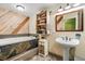 Updated bathroom with a soaking tub, rustic wood accents, and a pedestal sink at 724 Laurel Chase Sw, Marietta, GA 30064