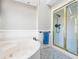 Bathroom featuring a tub and a shower separated with a gold-trimmed glass door at 724 Laurel Chase Sw, Marietta, GA 30064