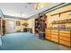 Large carpeted bonus room featuring built in cabinets, an antique clock, and ample storage at 724 Laurel Chase Sw, Marietta, GA 30064