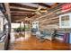 View of a covered wood deck with ceiling fans, furniture, and nostalgic Coca-Cola signs at 724 Laurel Chase Sw, Marietta, GA 30064