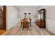 Elegant dining room with classic wainscoting, hardwood table and chairs, and French door access to patio at 724 Laurel Chase Sw, Marietta, GA 30064