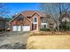 Classic brick two-story home with a two-car garage and mature trees in a well-manicured neighborhood at 724 Laurel Chase Sw, Marietta, GA 30064