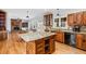 Open kitchen view with island, brick backsplash, and hardwood floors at 724 Laurel Chase Sw, Marietta, GA 30064