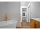 Elegant bathroom with a free-standing tub, vanity, and modern fixtures at 1027 Mount Airy Sw Dr, Atlanta, GA 30311