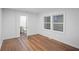 Bright bedroom with hardwood floors, white walls, and a view into the bathroom at 1027 Mount Airy Sw Dr, Atlanta, GA 30311