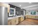 Bright kitchen featuring stainless steel appliances, light wood cabinets, and tiled backsplash at 1027 Mount Airy Sw Dr, Atlanta, GA 30311