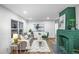 Bright living room with refinished hardwood floors and a decorative green fireplace at 1027 Mount Airy Sw Dr, Atlanta, GA 30311