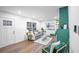 Bright living room with refinished hardwood floors and a decorative green fireplace at 1027 Mount Airy Sw Dr, Atlanta, GA 30311