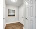 Entry hallway with hardwood flooring, neutral paint, and multiple white paneled doors at 1074 Peachtree Ne Walk # B306, Atlanta, GA 30309