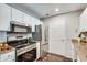 Well-equipped kitchen boasting stainless steel appliances, white cabinets, and a convenient layout at 1074 Peachtree Ne Walk # B306, Atlanta, GA 30309