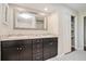 Bathroom with double sink vanity, granite countertops, a large mirror, and decorative tile flooring at 1883 Acuba Ln, Atlanta, GA 30345