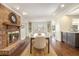 Formal dining room with a brick fireplace, custom built-ins, and view to kitchen at 1883 Acuba Ln, Atlanta, GA 30345