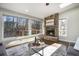 Sun-drenched sunroom with a stone fireplace and large windows overlooking a wooded backyard at 1883 Acuba Ln, Atlanta, GA 30345