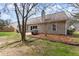 A spacious backyard with a patio and mature trees offers a tranquil outdoor space at 2405 Landrum Ct, Lawrenceville, GA 30043