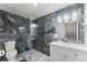 Sleek bathroom featuring glass shower and modern vanity with onyx-style stone at 2405 Landrum Ct, Lawrenceville, GA 30043