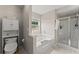 Clean bathroom with shower, soaking tub, and updated fixtures at 2405 Landrum Ct, Lawrenceville, GA 30043