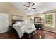 Bedroom with vaulted ceilings, hardwood floors, a ceiling fan, and large windows at 2405 Landrum Ct, Lawrenceville, GA 30043