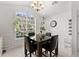 Cozy breakfast nook with a large window, chandelier, and comfortable seating area at 2405 Landrum Ct, Lawrenceville, GA 30043