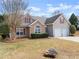 Beautiful two-story home with a two-car garage, stone accents, and a landscaped front yard at 2405 Landrum Ct, Lawrenceville, GA 30043