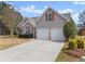 Charming two-story home with a two-car garage and a well-manicured lawn and stone accents at 2405 Landrum Ct, Lawrenceville, GA 30043