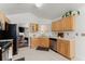 Bright kitchen featuring stainless steel appliances, light wood cabinetry, and a seamless flow into the adjacent living area at 2405 Landrum Ct, Lawrenceville, GA 30043