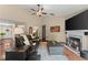 Bright living room featuring hardwood floors, a fireplace and views of the front yard at 2405 Landrum Ct, Lawrenceville, GA 30043