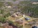 Aerial view of the property and surrounding area, showing nearby homes and wooded areas at 2999 Paul Harris Rd, Dallas, GA 30157