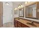 Bathroom featuring double sinks, granite countertops, and decorative mirrors at 2999 Paul Harris Rd, Dallas, GA 30157