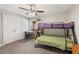 ' bedroom with carpet, ceiling fan, bunk beds, desk, and storage at 2999 Paul Harris Rd, Dallas, GA 30157