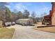 Large detached three-car garage with a long driveway and recreational features such as a trampoline at 2999 Paul Harris Rd, Dallas, GA 30157