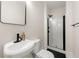 Modern bathroom with a walk-in shower featuring black hardware and a sleek design at 1057 Fortress Sw Ave, Atlanta, GA 30315