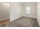 Neutral bedroom with carpet and hardwood floors, window, and doorway at 1057 Fortress Sw Ave, Atlanta, GA 30315