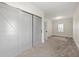 Bedroom featuring carpeted floors, white sliding barn doors, and natural light at 1057 Fortress Sw Ave, Atlanta, GA 30315