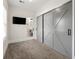 Bedroom with gray sliding closet doors, a wall-mounted television, and ensuite bathroom at 1057 Fortress Sw Ave, Atlanta, GA 30315