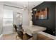 Modern dining area with stylish light fixture, dark accent wall and hardwood flooring at 1057 Fortress Sw Ave, Atlanta, GA 30315