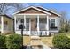 Charming home exterior with covered porch, gray siding, and a beautifully landscaped front yard at 1057 Fortress Sw Ave, Atlanta, GA 30315