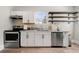 Contemporary kitchen featuring stainless steel appliances, white cabinets, and hardwood floors at 1057 Fortress Sw Ave, Atlanta, GA 30315