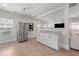 Bright open floorplan featuring stainless steel fridge, and open kitchen with white cabinets at 1057 Fortress Sw Ave, Atlanta, GA 30315