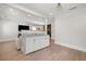 Open-concept living area featuring modern cabinetry with marble countertops and hardwood flooring at 1057 Fortress Sw Ave, Atlanta, GA 30315