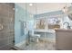 Stylish bathroom showcasing a glass-enclosed shower, a modern vanity, and bright windows, creating a spa-like experience at 1848 Flagler Ne Ave, Atlanta, GA 30309