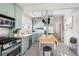 Well-lit kitchen with stainless steel appliances, plenty of counter space, and mint green cabinets at 1848 Flagler Ne Ave, Atlanta, GA 30309