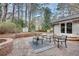 Relaxing brick patio with outdoor seating, string lights, and a view of the backyard at 2031 Audubon Ne Dr, Atlanta, GA 30329