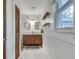 A bathroom showing a double sink vanity, tile floors, and a window with natural light at 2031 Audubon Ne Dr, Atlanta, GA 30329