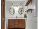 A bathroom showing a double sink vanity, tile floors, and pendant style lighting at 2031 Audubon Ne Dr, Atlanta, GA 30329