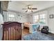 Charming Bedroom with hardwood floors, natural light, playful space themed wall stickers, and blue patterned rug at 2031 Audubon Ne Dr, Atlanta, GA 30329