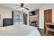 A bedroom with a fireplace, mounted TV, and doors leading to an outdoor patio at 2031 Audubon Ne Dr, Atlanta, GA 30329